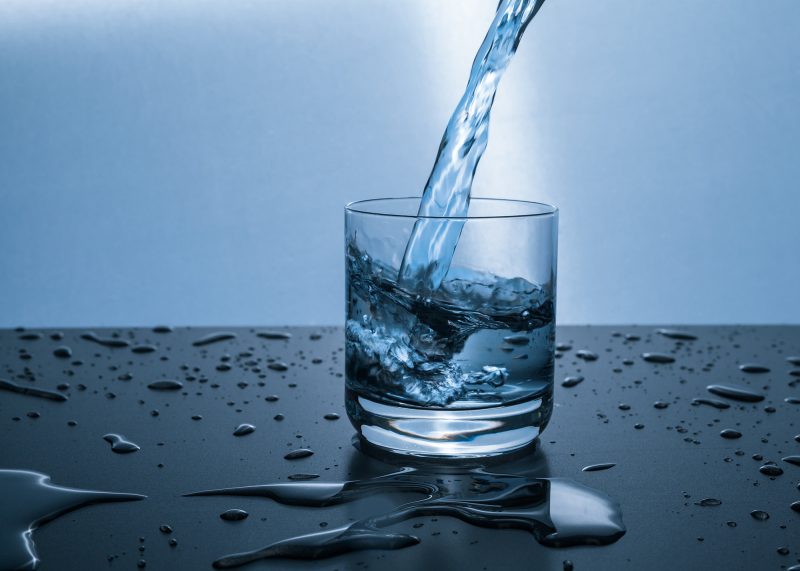 water being poured into a clear glass